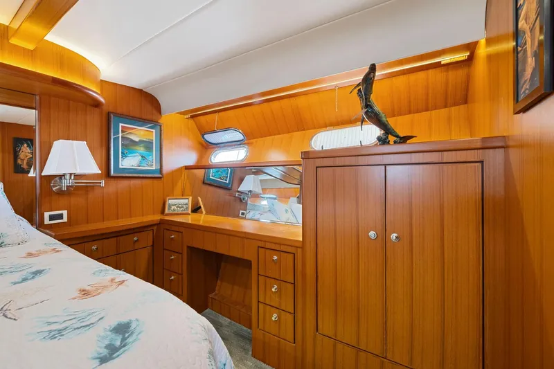 Ds Gatos Yacht Photos Pics Luxurious wooden interior of a 1999 Symbol 558 yacht cabin with elegant decor.