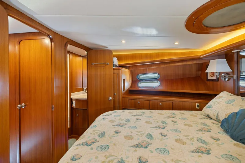 Ds Gatos Yacht Photos Pics Luxurious yacht bedroom with wood paneling, porthole windows, and elegant bedding, Symbol 558, 1999.