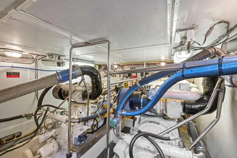 Ds Gatos Yacht Photos Pics Engine room of a 1999 Symbol 558 yacht, featuring complex machinery and piping.