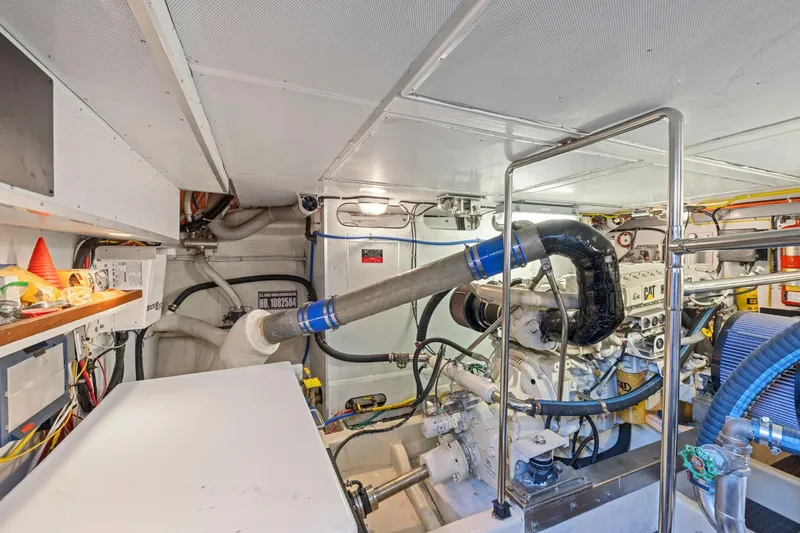 Ds Gatos Yacht Photos Pics Engine room of a 1999 Symbol 558 yacht, featuring complex machinery and piping.