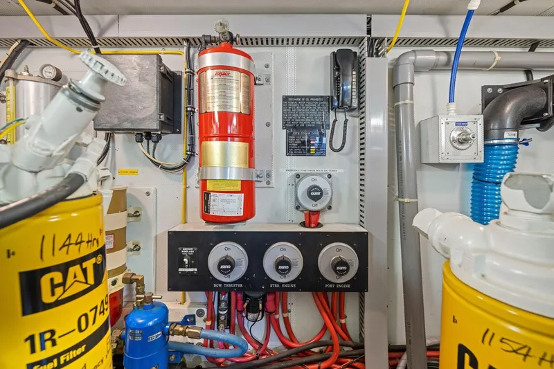 Ds Gatos Yacht Photos Pics Engine room with CAT filters, fire extinguisher, and control panel, Symbol 558, 1999 model.