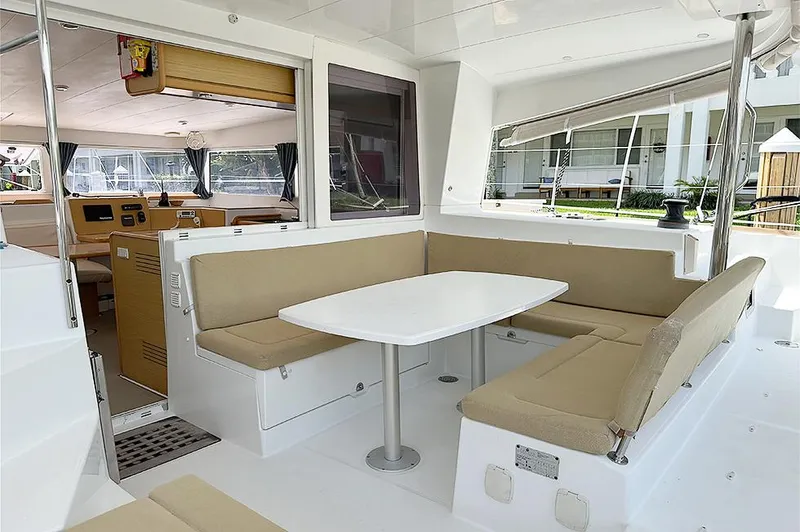 Selkie Yacht Photos Pics Spacious interior of 2012 Lagoon 400 catamaran with beige seating and white table.