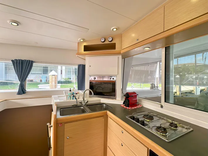 Selkie Yacht Photos Pics Modern kitchen interior of 2012 Lagoon 400 catamaran with stove, sink, and appliances.