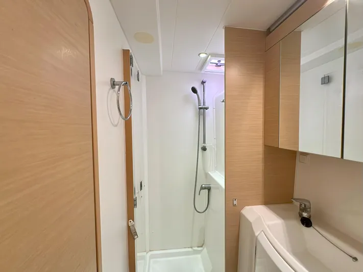 Selkie Yacht Photos Pics Modern bathroom interior of 2012 Lagoon 400 yacht with shower and sink.