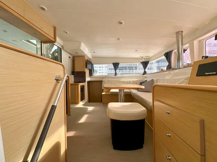 Selkie Yacht Photos Pics Interior of 2012 Lagoon 400 catamaran with modern wood finish and ample seating.