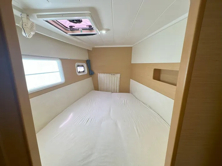 Selkie Yacht Photos Pics Interior cabin of 2012 Lagoon 400 catamaran with bed and porthole windows.