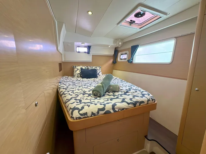 Selkie Yacht Photos Pics Luxurious cabin interior of 2012 Lagoon 400 catamaran with cozy bedding and natural light.