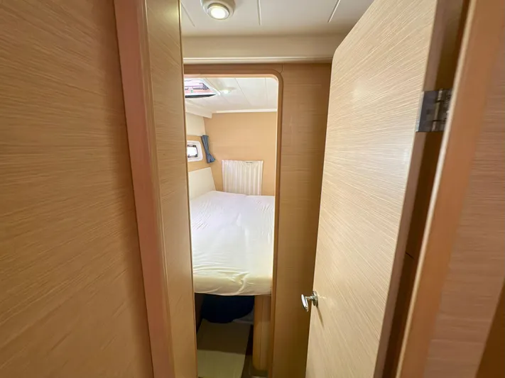 Selkie Yacht Photos Pics Interior cabin of 2012 Lagoon 400 catamaran with cozy bed and wooden finish.