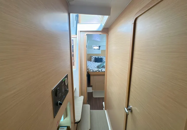 Selkie Yacht Photos Pics Interior view of 2012 Lagoon 400 yacht cabin with wooden finish and cozy bed.