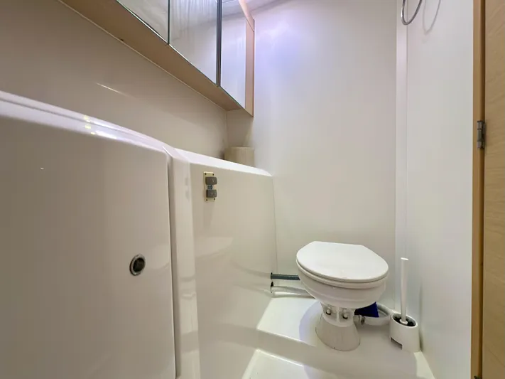 Selkie Yacht Photos Pics Bathroom interior of 2012 Lagoon 400 yacht, featuring a compact marine toilet.