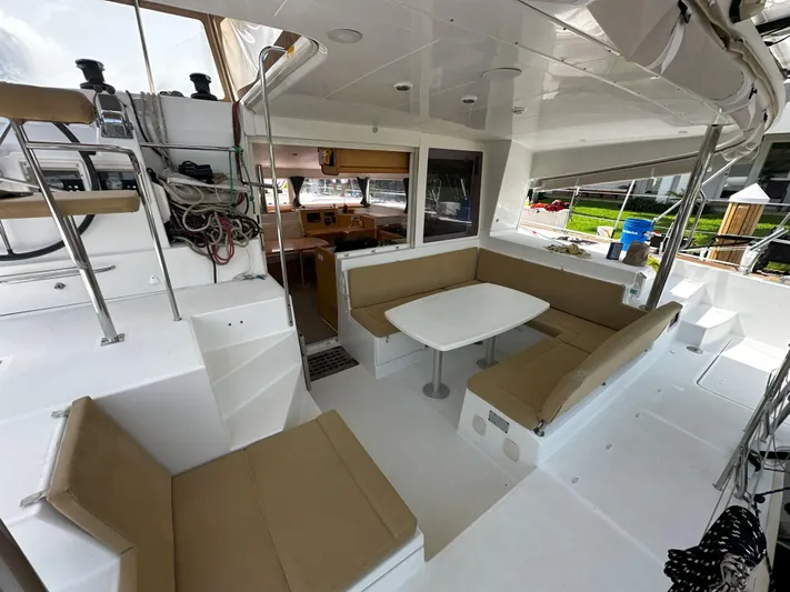 Selkie Yacht Photos Pics Spacious 2012 Lagoon 400 catamaran cockpit with seating and table, ideal for relaxation.