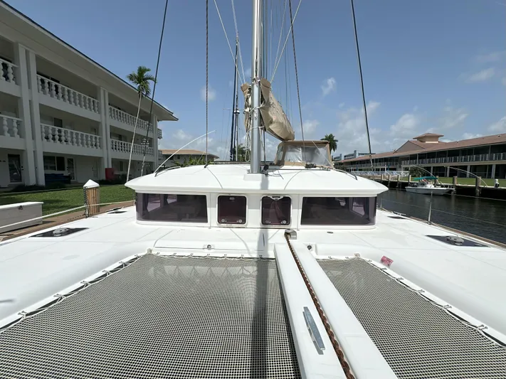 Selkie Yacht Photos Pics 2012 Lagoon 400 catamaran docked near waterfront buildings under clear blue sky.