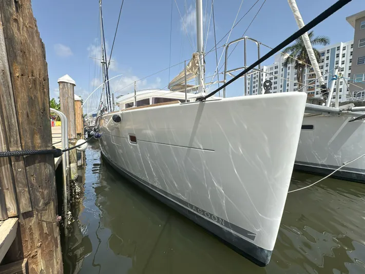 Selkie Yacht Photos Pics 2012 Lagoon 400 catamaran docked at marina under clear blue sky.
