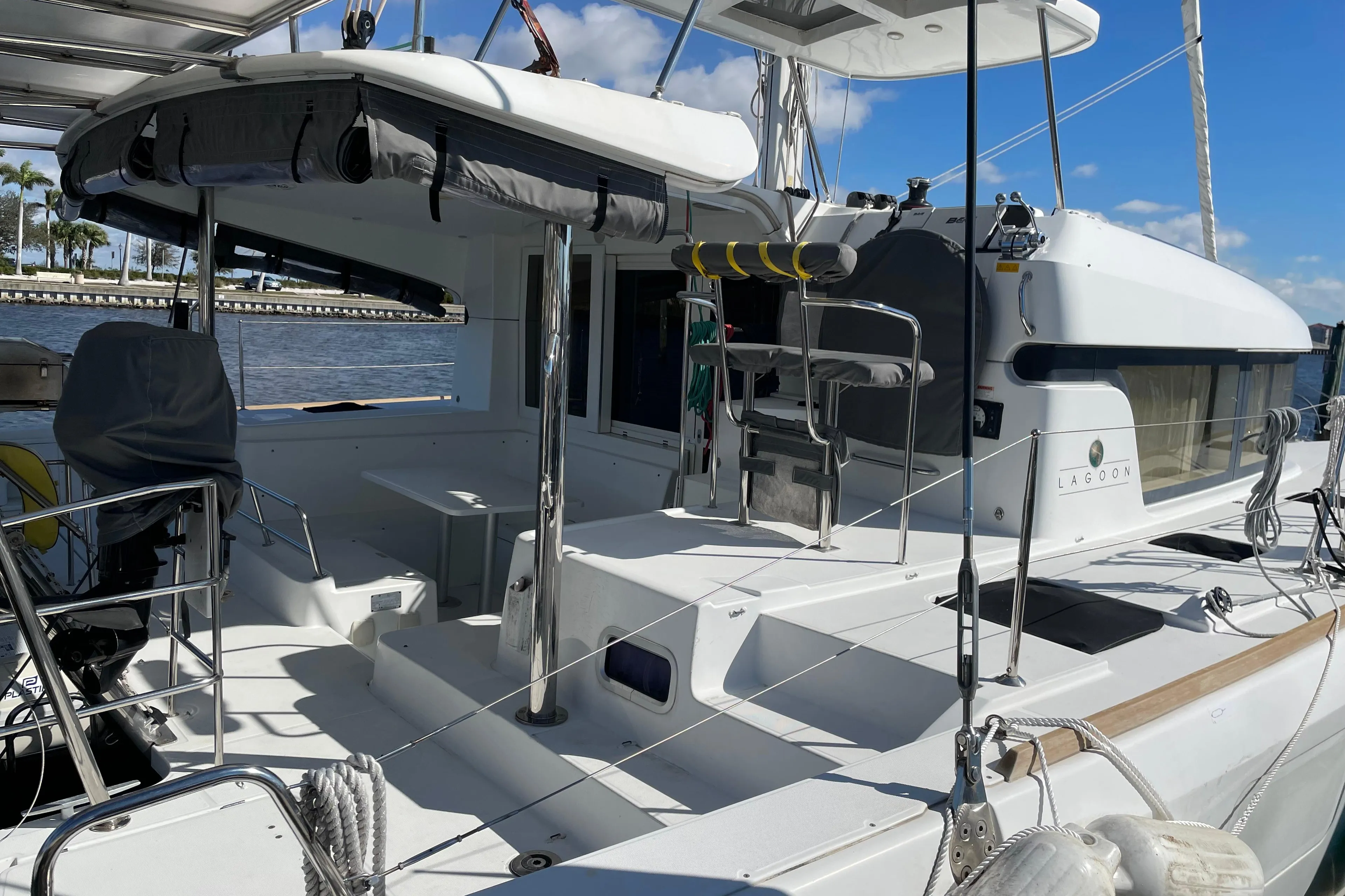 2017 Lagoon 39 catamaran with spacious deck, docked by the water under a clear blue sky.