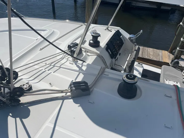 Sun Bums Yacht Photos Pics 2017 Lagoon 39 sailboat deck with winches and ropes, docked at marina.