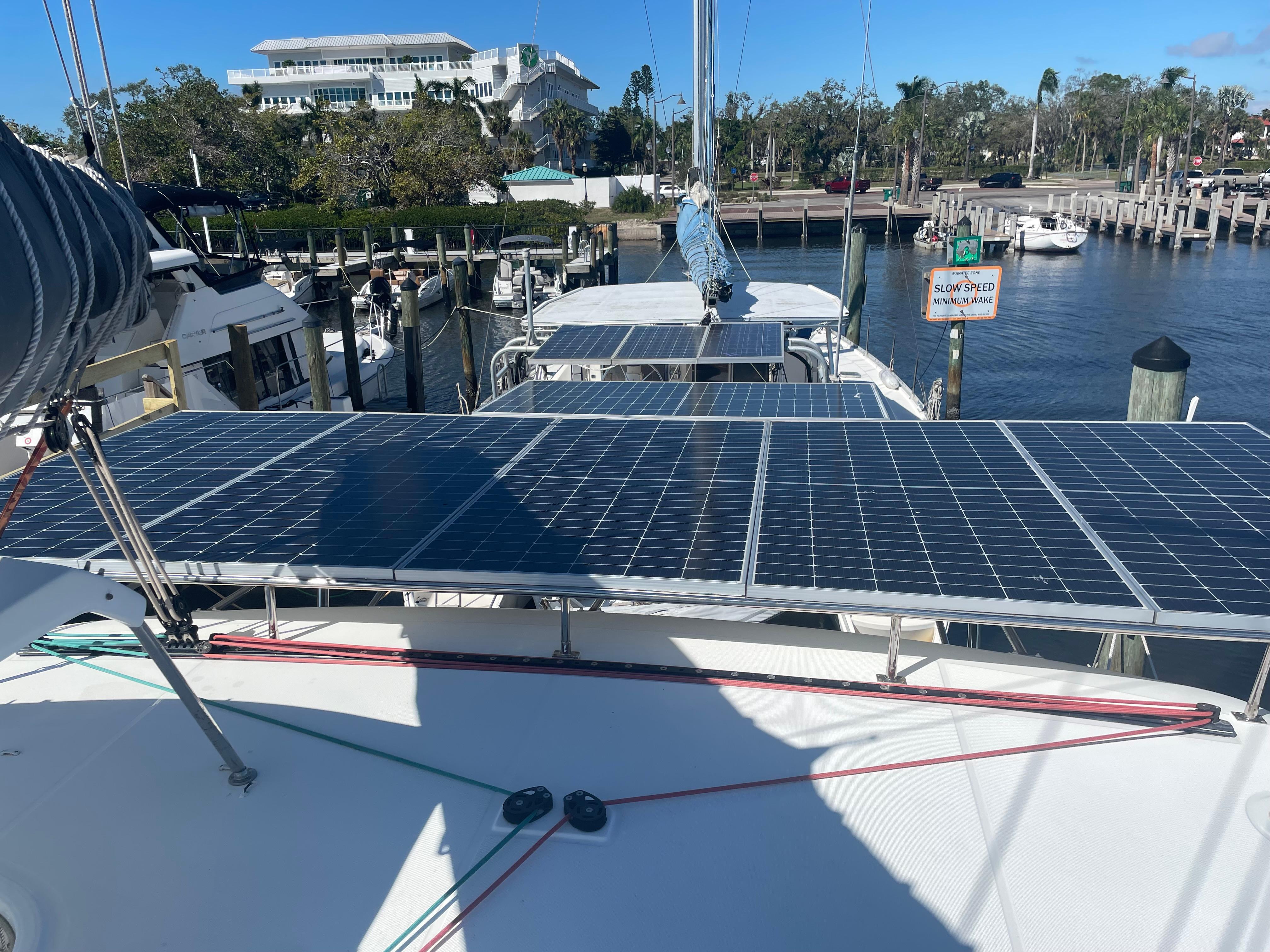2017 Lagoon 39 catamaran with solar panels docked at a marina.