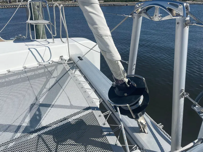Sun Bums Yacht Photos Pics 2017 Lagoon 39 catamaran deck with rigging and netting over water.