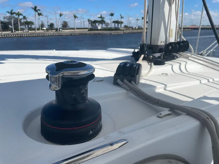 Sun Bums Yacht Photos Pics Lagoon 39 sailboat deck with winch, ropes, and palm trees in the background, 2017 model.