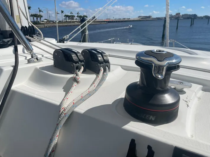 Sun Bums Yacht Photos Pics Close-up of 2017 Lagoon 39 sailboat deck with winch and ropes by the water.