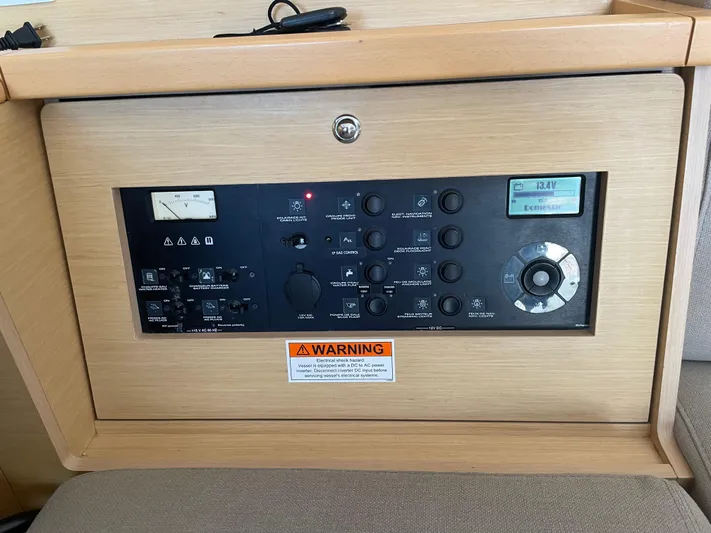 Sun Bums Yacht Photos Pics Control panel of a 2017 Lagoon 39 yacht with various switches and warning label.