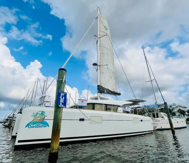 Sun Bums Yacht Photos Pics 2017 Lagoon 39 catamaran "SunBums" docked at marina under cloudy sky.