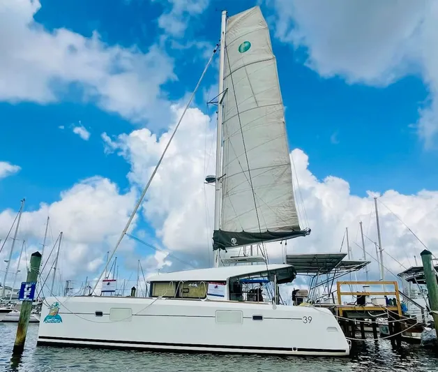 Sun Bums Yacht Photos Pics 2017 Lagoon 39 catamaran docked under a vibrant blue sky.