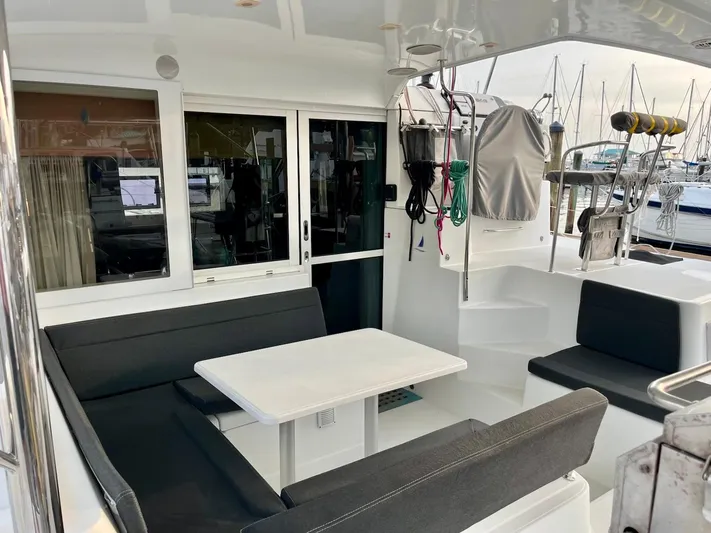 Sun Bums Yacht Photos Pics 2017 Lagoon 39 yacht cockpit with seating, table, and marina view.