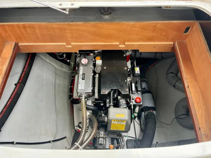 Sun Bums Yacht Photos Pics Engine compartment of a 2017 Lagoon 39 catamaran, showcasing mechanical components and hoses.