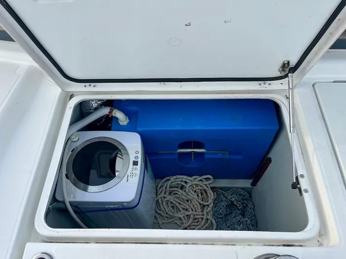 Sun Bums Yacht Photos Pics Storage compartment on a 2017 Lagoon 39 boat with washing machine and ropes.