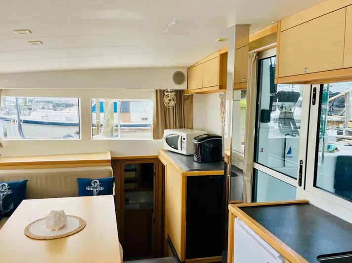 Sun Bums Yacht Photos Pics Interior of 2017 Lagoon 39 catamaran with modern kitchen and dining area.