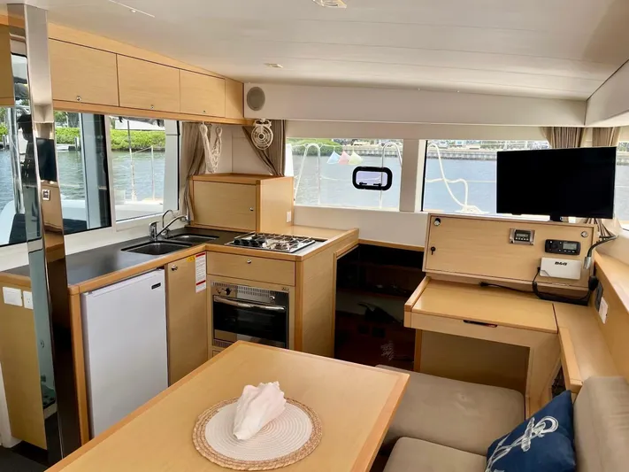 Sun Bums Yacht Photos Pics Interior of 2017 Lagoon 39 catamaran with modern kitchen, dining area, and waterfront view.