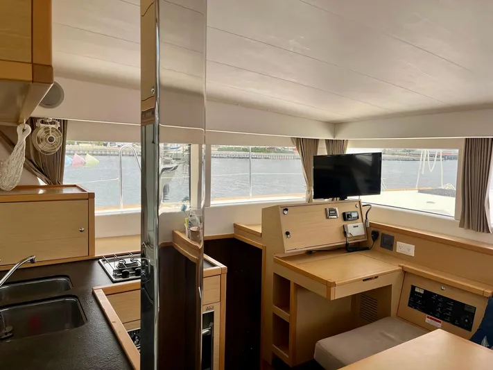 Sun Bums Yacht Photos Pics Interior of 2017 Lagoon 39 catamaran with modern kitchen and navigation station.