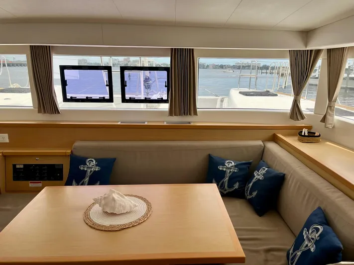 Sun Bums Yacht Photos Pics Interior of 2017 Lagoon 39 catamaran with cozy seating and nautical-themed decor.