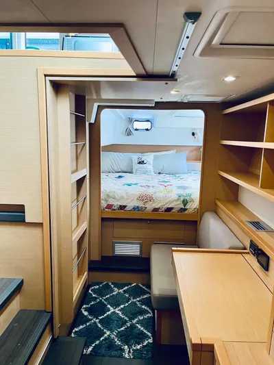 Sun Bums Yacht Photos Pics Interior of 2017 Lagoon 39 catamaran featuring cozy cabin with bed and wooden furnishings.