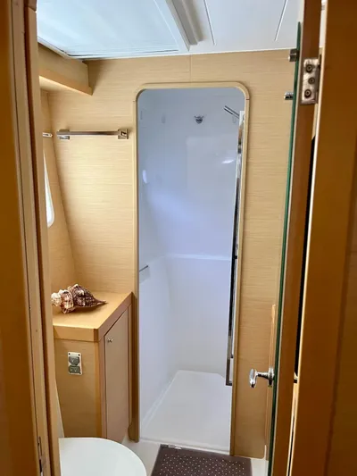 Sun Bums Yacht Photos Pics Interior of a 2017 Lagoon 39 yacht bathroom with modern fixtures and wooden accents.