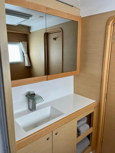 Sun Bums Yacht Photos Pics Modern bathroom interior in a 2017 Lagoon 39 yacht with mirror and sink.