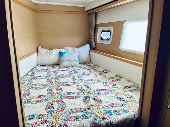 Sun Bums Yacht Photos Pics Cozy cabin bedroom in 2017 Lagoon 39 catamaran with colorful quilt and window view.