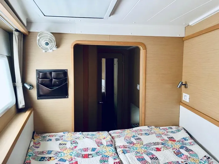 Sun Bums Yacht Photos Pics Cozy cabin interior of 2017 Lagoon 39 catamaran with colorful quilted bedding.