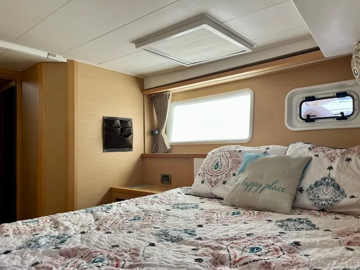 Sun Bums Yacht Photos Pics Cozy bedroom interior of 2017 Lagoon 39 yacht with floral bedding and natural light.