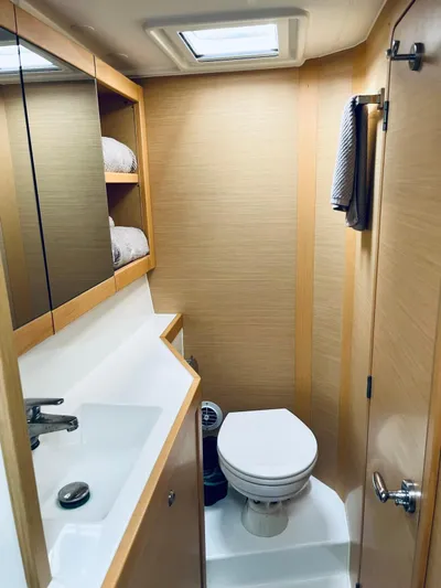 Sun Bums Yacht Photos Pics 2017 Lagoon 39 yacht bathroom with modern fixtures and wooden cabinetry.