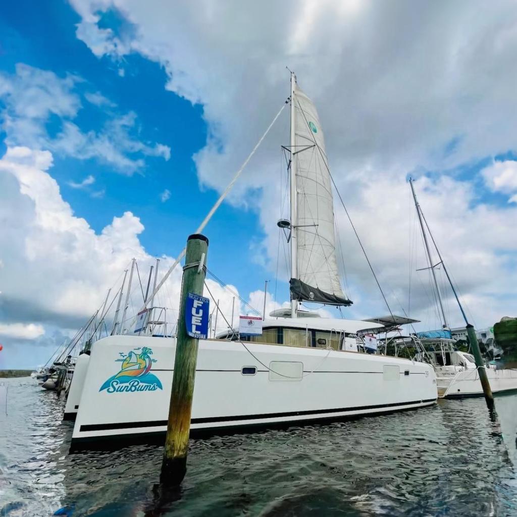 2017 Lagoon 39 catamaran "SunBums" docked at marina under cloudy sky.