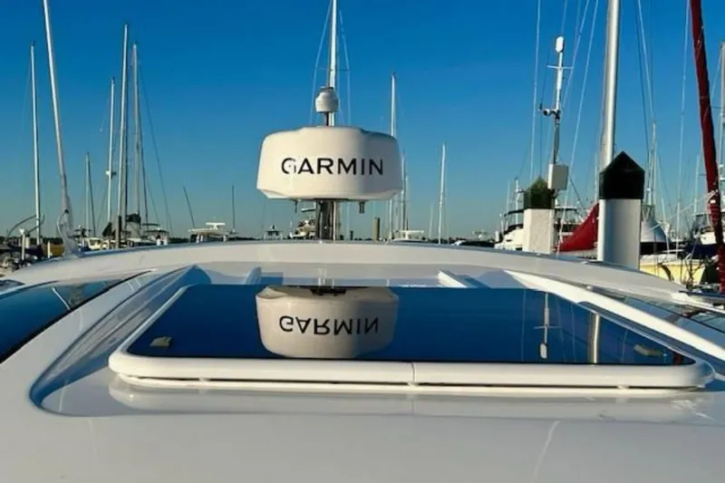  Yacht Photos Pics 2024 Beneteau Antares 9 with Garmin radar, docked in a marina under clear blue skies.