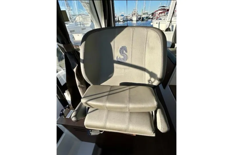  Yacht Photos Pics Captain's seat on 2024 Beneteau Antares 9 boat, featuring embroidered logo.