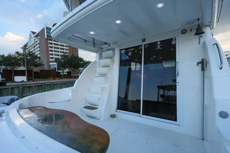 My Gypsy Soul Yacht Photos Pics 2004 Meridian 411 Sedan yacht with sleek design, docked near modern buildings.