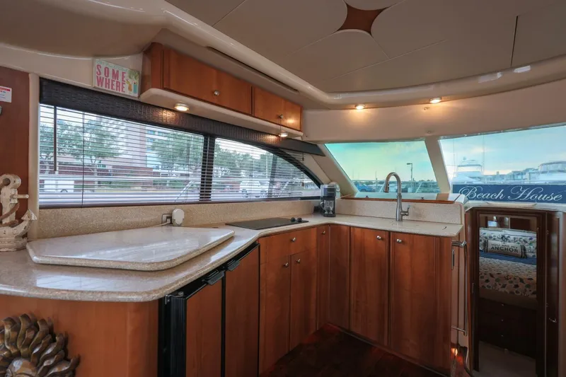 My Gypsy Soul Yacht Photos Pics Luxurious kitchen interior of 2004 Meridian 411 Sedan yacht with wooden cabinetry and modern amenities.