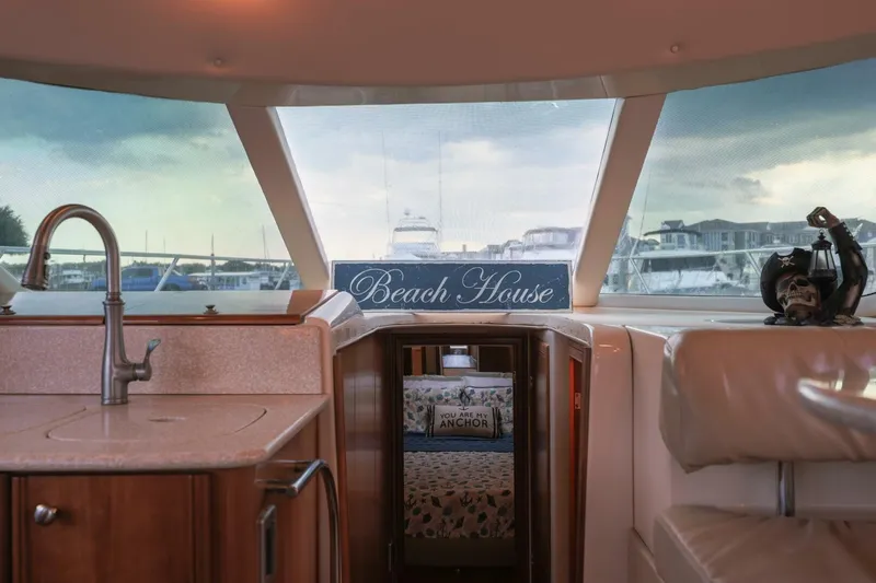 My Gypsy Soul Yacht Photos Pics Interior of 2004 Meridian 411 Sedan yacht with "Beach House" sign and nautical decor.