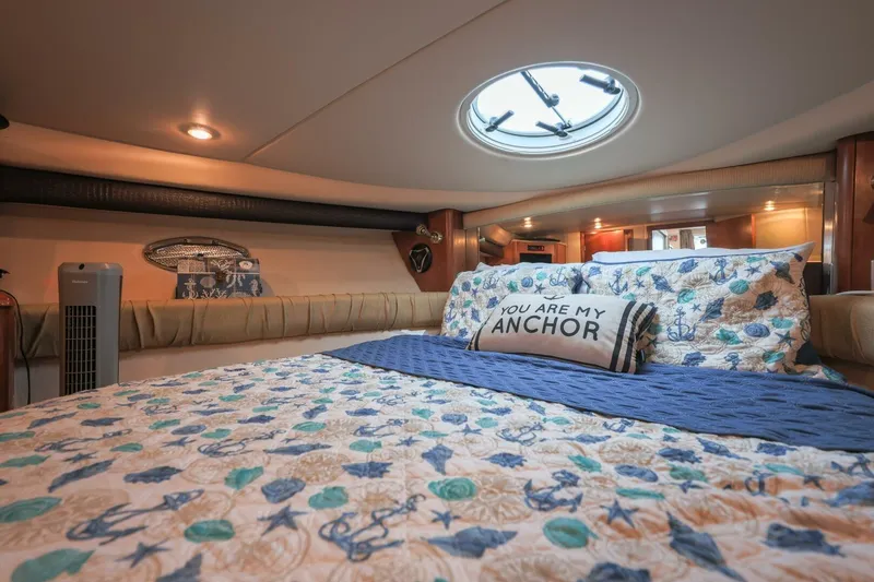 My Gypsy Soul Yacht Photos Pics Luxurious 2004 Meridian 411 Sedan bedroom with nautical-themed bedding and decorative pillow.