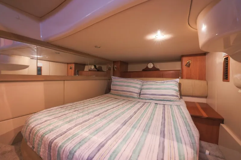 My Gypsy Soul Yacht Photos Pics Luxurious bedroom interior of 2004 Meridian 411 Sedan yacht with striped bedding.