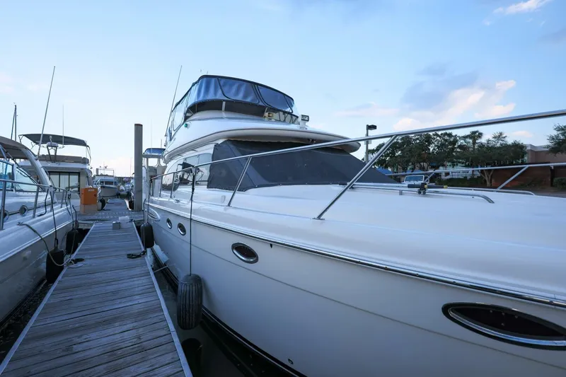 My Gypsy Soul Yacht Photos Pics 2004 Meridian 411 Sedan yacht docked at marina under blue sky.