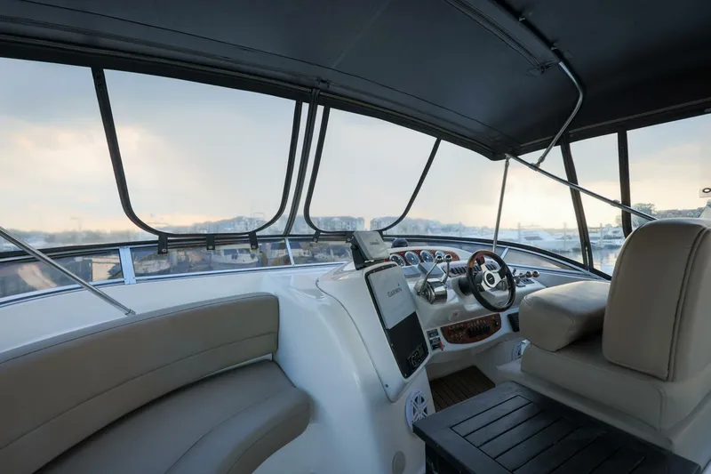 My Gypsy Soul Yacht Photos Pics Interior view of 2004 Meridian 411 Sedan yacht cockpit with steering wheel and seating.